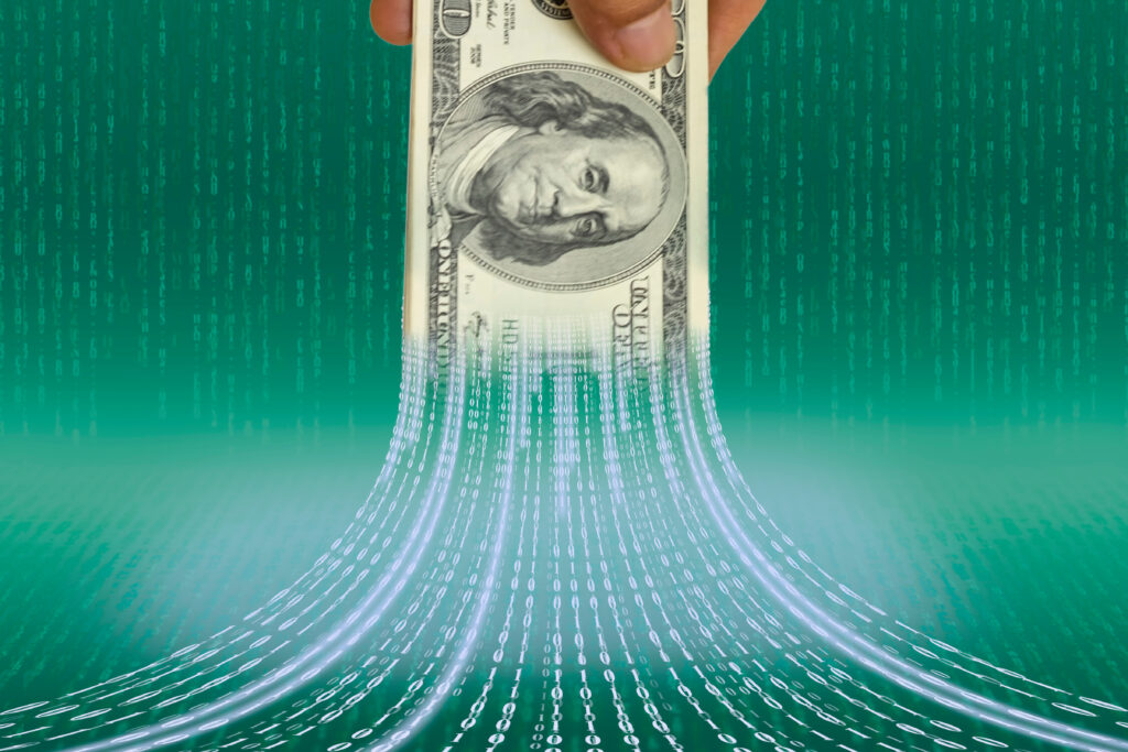 A 100 dollar bill being shredded into code as Cyber Financial Attacks