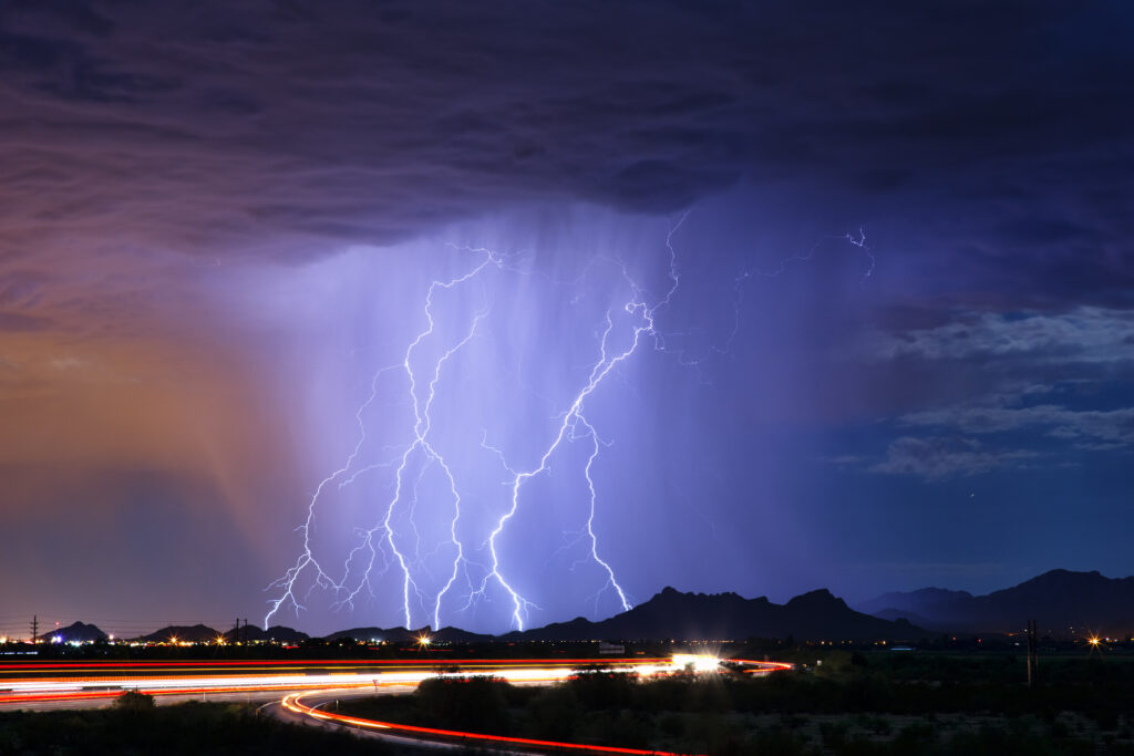 A picture of Lightning strike and thunderstorm over a city at night - Extreme Weather Protection for Electronic Devices