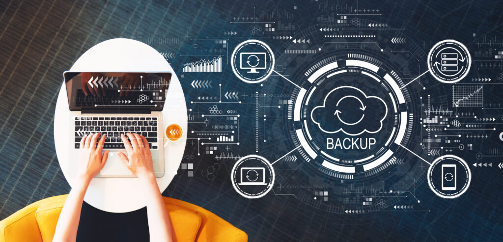 Disaster Recovery and Backup concept with person using a laptop on a white table